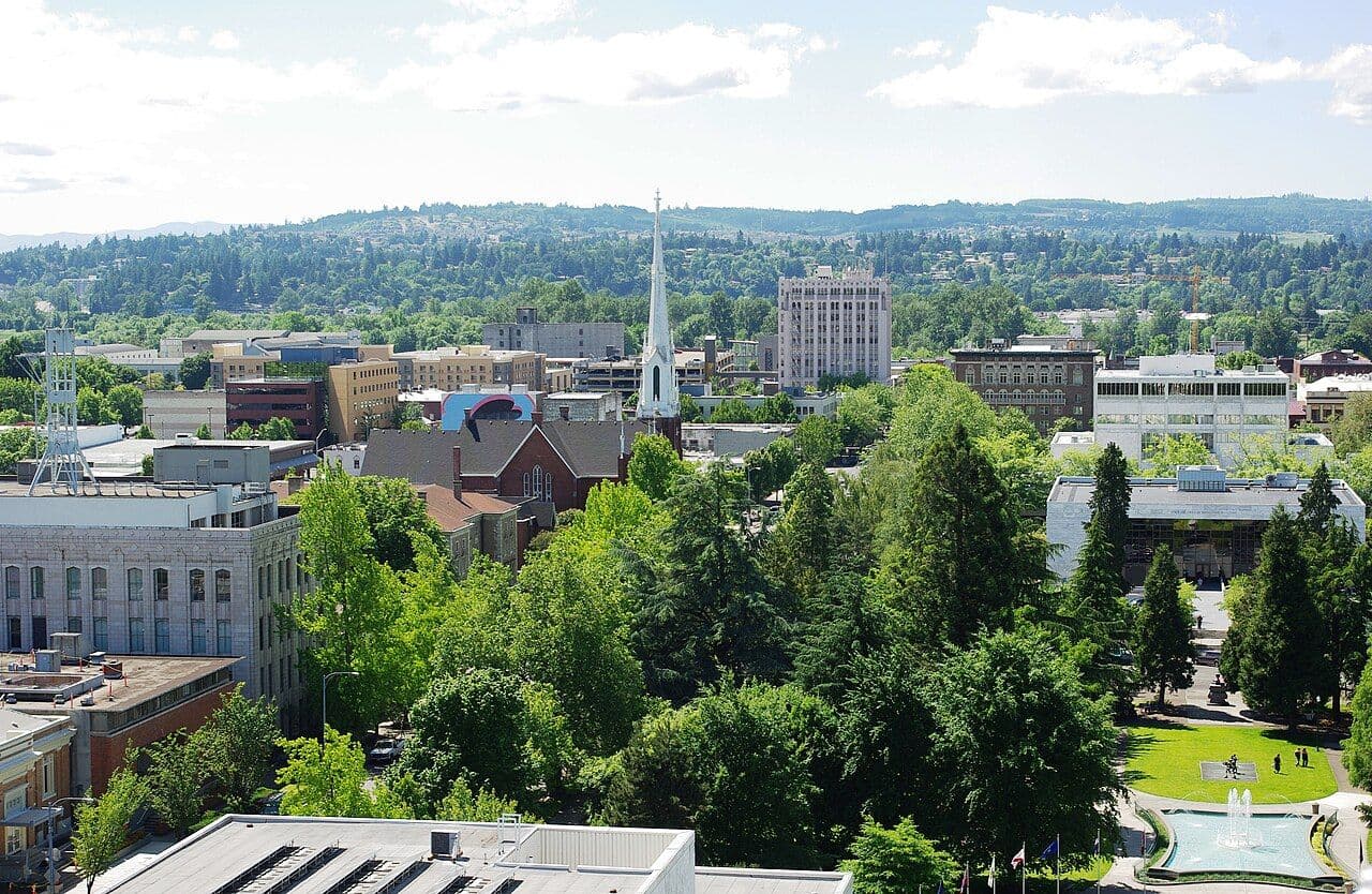 Downtown Salem seen from the top of the Oregon State Capitol, with tree-lined streets and hills beyond.